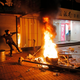 A rioter tries to throw bricks at police in the Mong Kok district of Hong Kong, Feb. 9, 2016, during the Lunar New Year holiday.